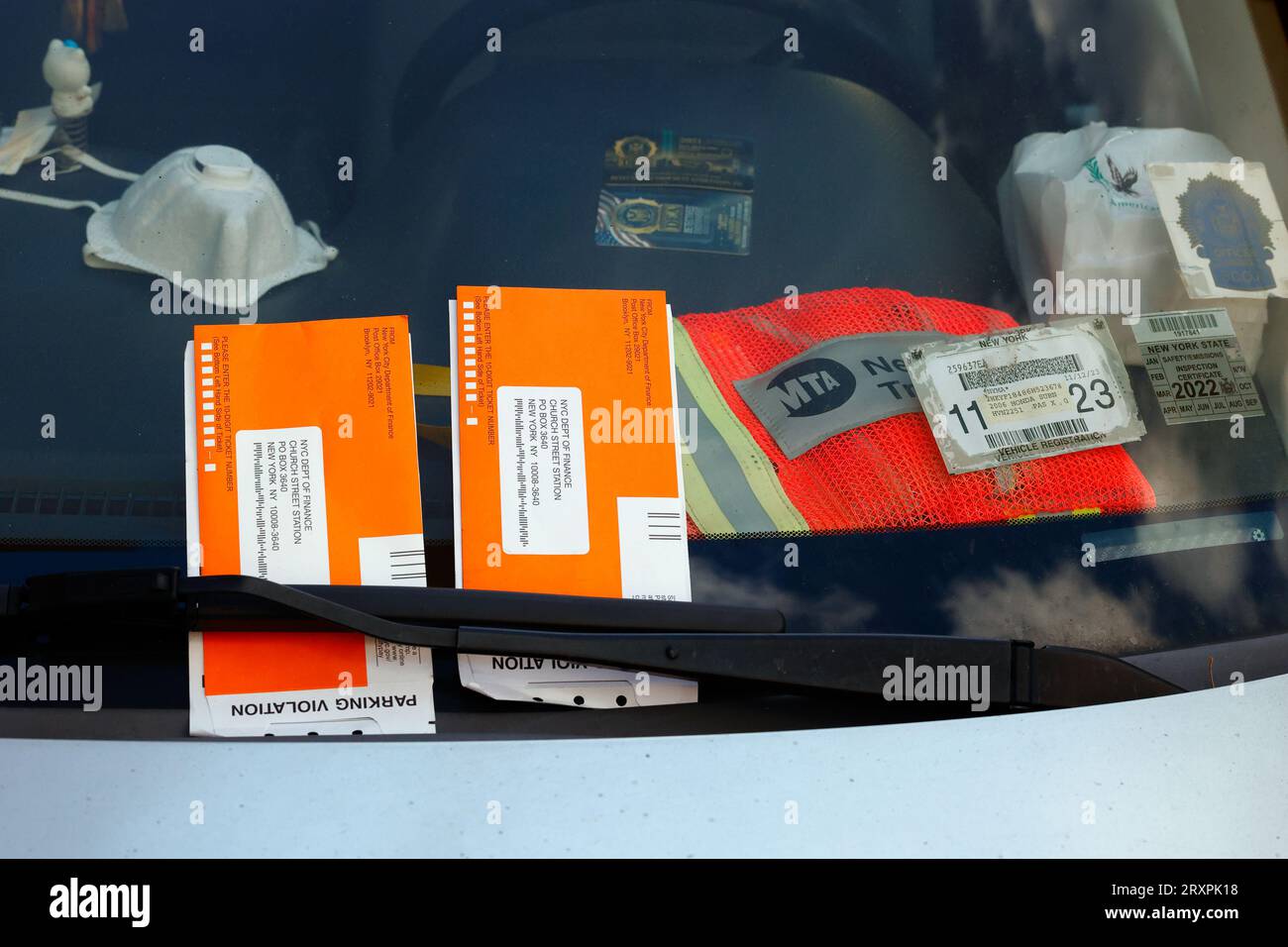 Vehicle in New York City with police courtesy cards, work identification, and placards used to deter traffic agents from issuing parking tickets. Stock Photo