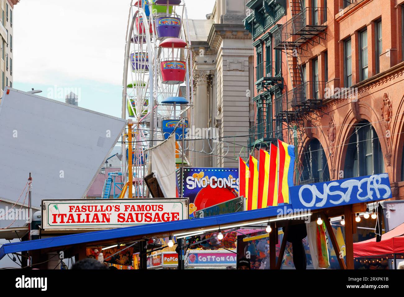 Amusement rides, carnival games, Italian sausage and peppers, oysters, and more at the San Gennaro Feast street fair in Little Italy, New York City. Stock Photo