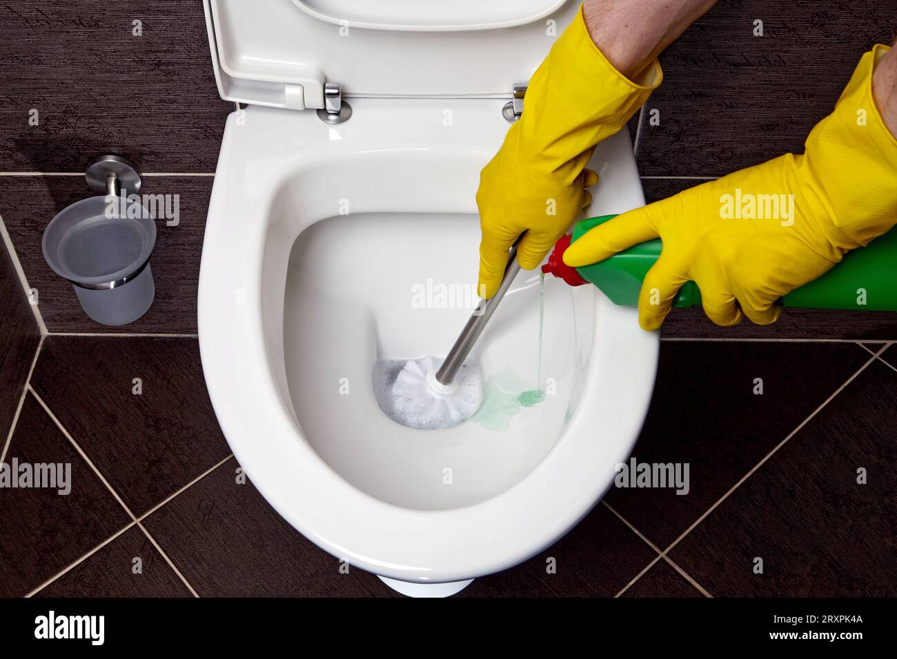 Homework for cleaning and disinfecting the toilet. Person in yellow