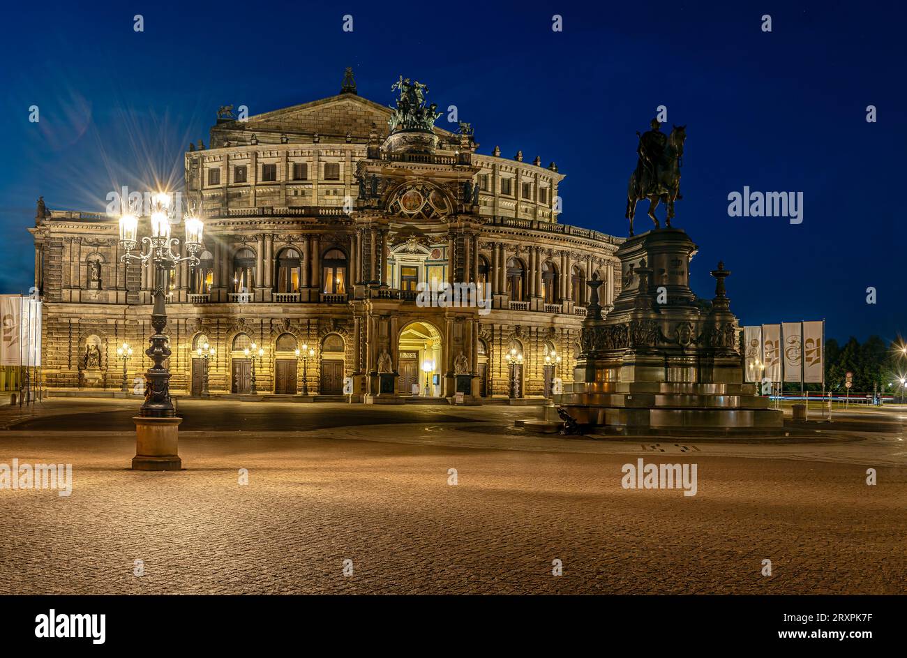 Semperoper at old town of Dresden at night, Saxony, Germany with the equestrian monument of King Johann in the foreground Stock Photo