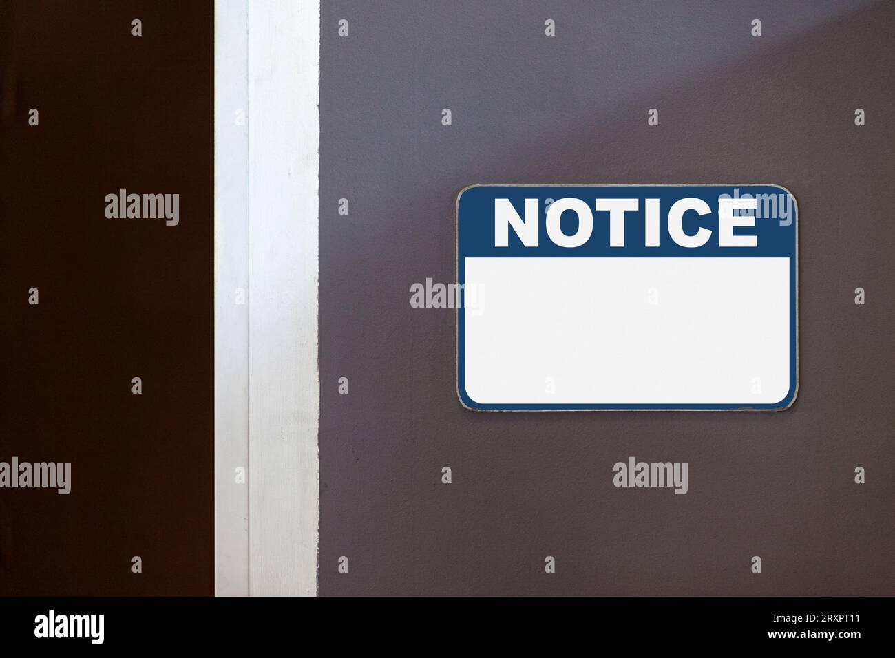 Blue and white notice sign with copy space on the side of an open door. Stock Photo