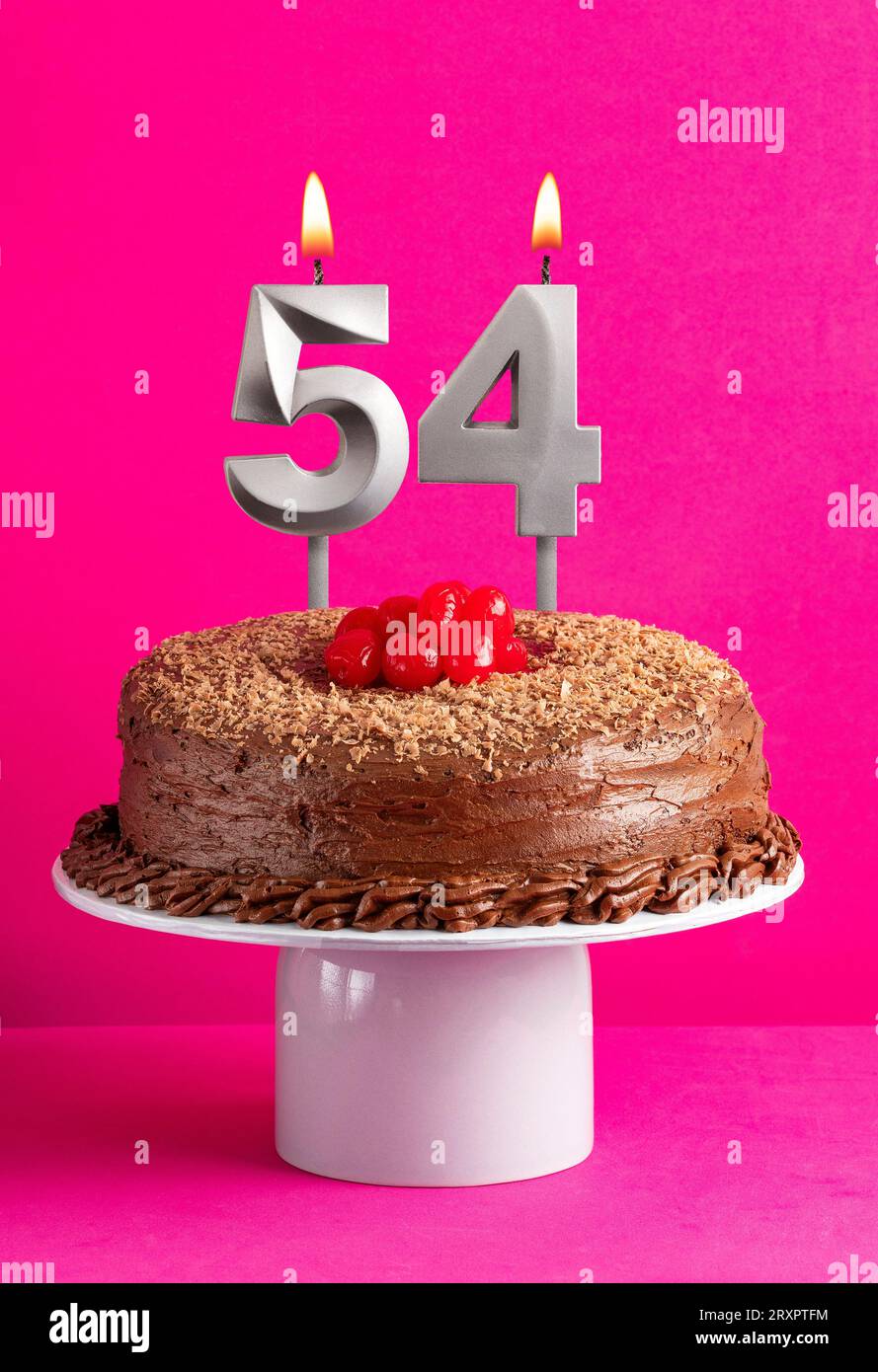 Birthday card with candle number 54 - Chocolate cake on pink background Stock Photo