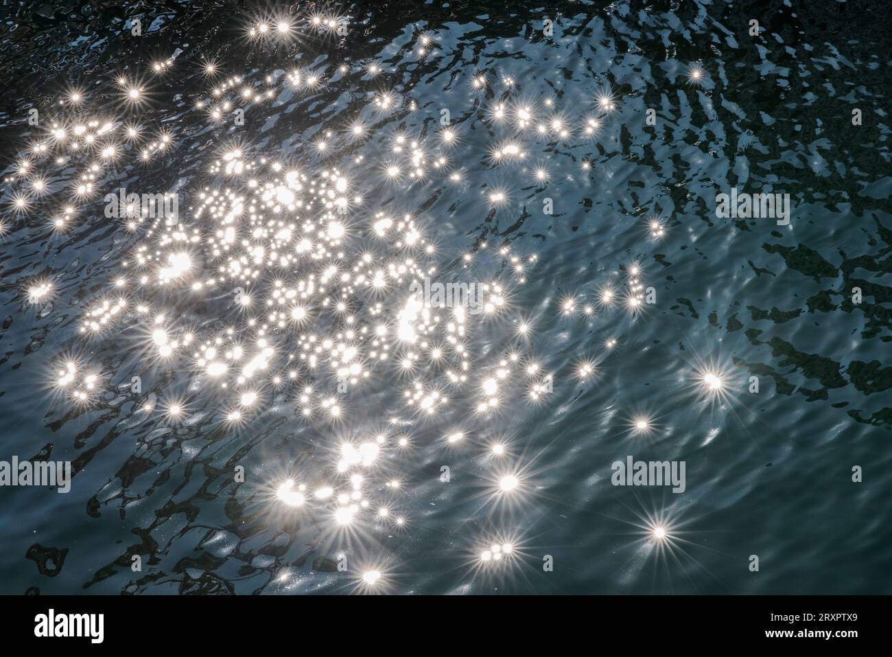 Bright sunlight sparkles on the clear blue water of the Pacific Ocean ...