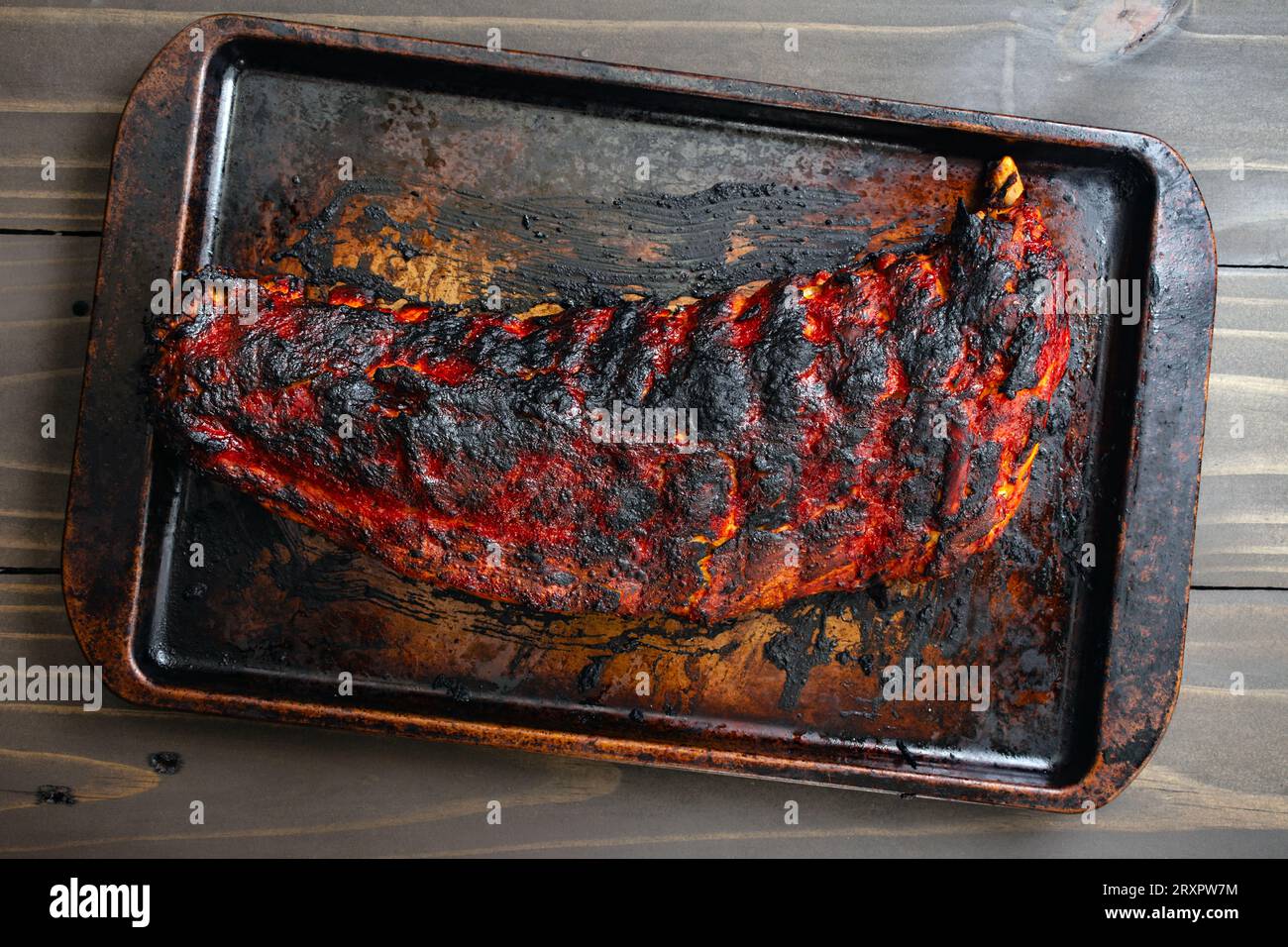 External Ribs On Sheet Rack of Baby Back Ribs on a Sheet Pan: A cooked rack of pork loin ribs ...