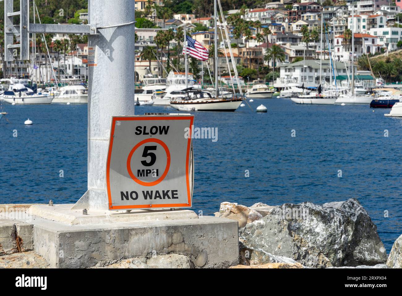 Avalon, CA, USA - September 13, 2023: Slow, 5 MPH, No Wake posted sign at the Avalon Harbor at Catalina Island in California. Stock Photo