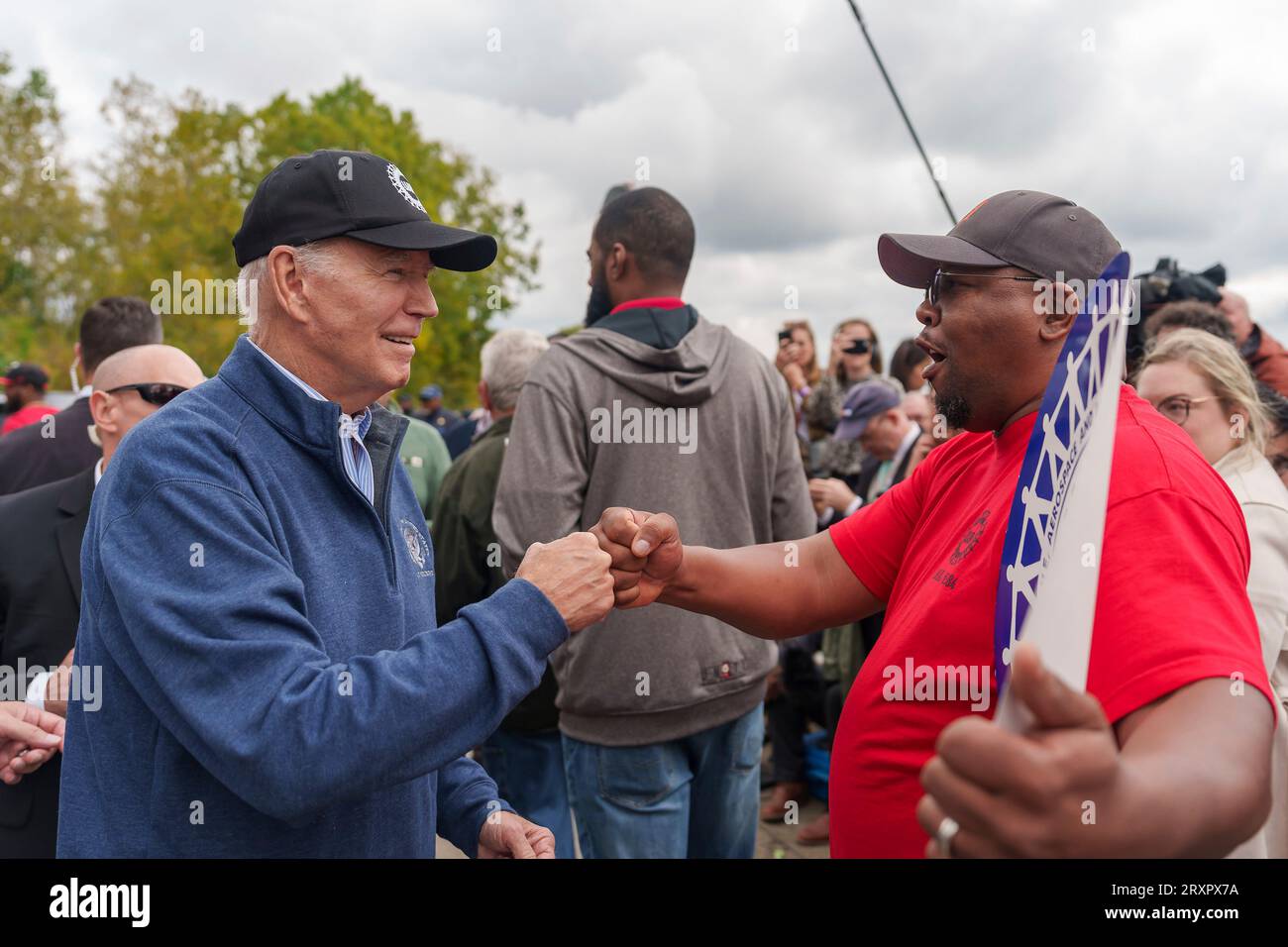 Belleville, United States. 26th Sep, 2023. U.S. President Joe Biden, left, fist-bumps union workers as he joined the United Auto Workers picket line outside the GM Willow Run Distribution Center, September 26, 2023, in Belleville, Michigan. Biden is the first sitting president to join a picket line in support for union workers. Credit: Adam Schultz/White House Photo/Alamy Live News Stock Photo
