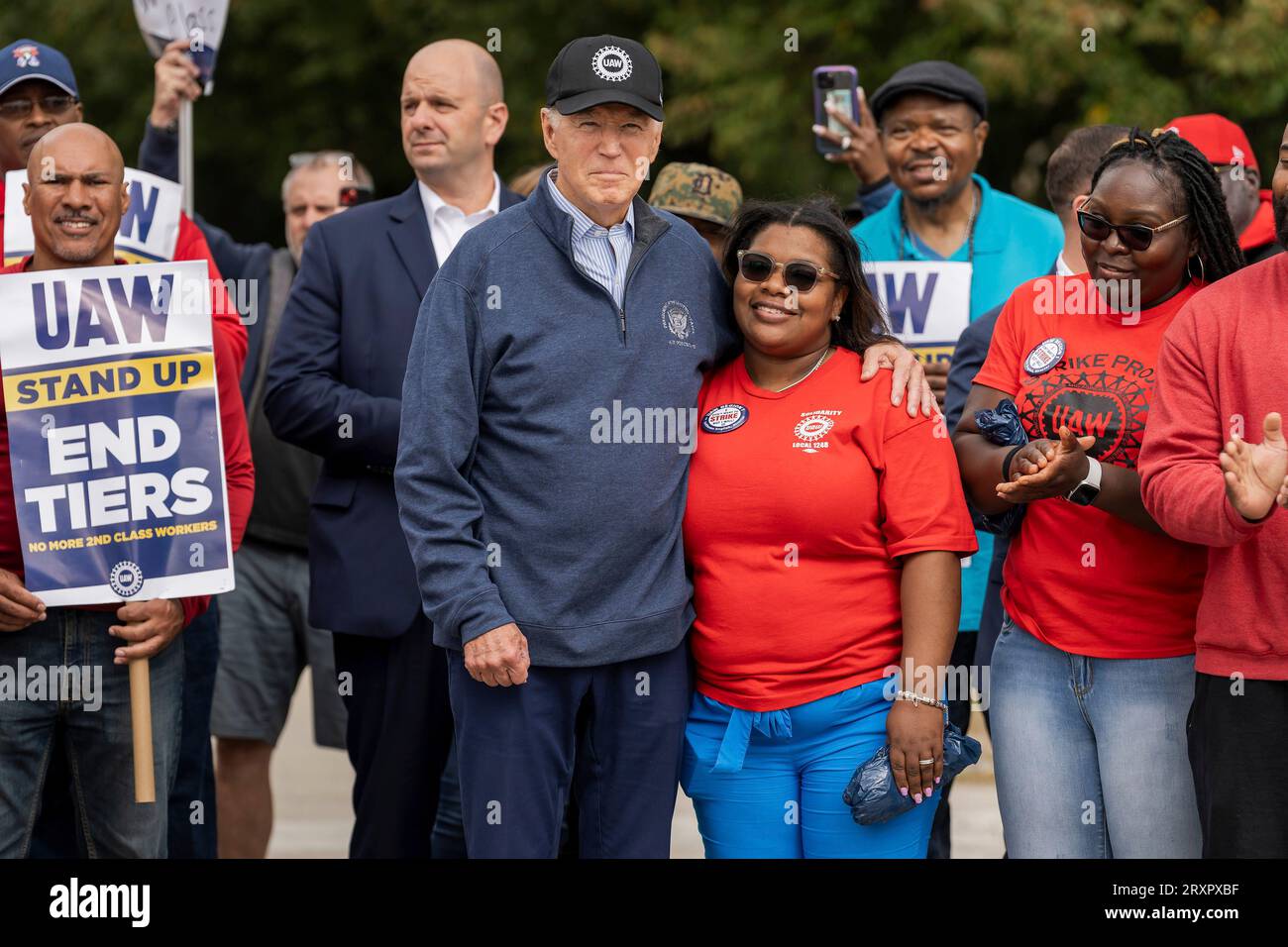 Belleville, United States. 26th Sep, 2023. U.S. President Joe Biden embraces union workers as he joins the United Auto Workers picket line outside the GM Willow Run Distribution Center, September 26, 2023, in Belleville, Michigan. Biden is the first sitting president to join a picket line in support for union workers. Credit: Adam Schultz/White House Photo/Alamy Live News Stock Photo