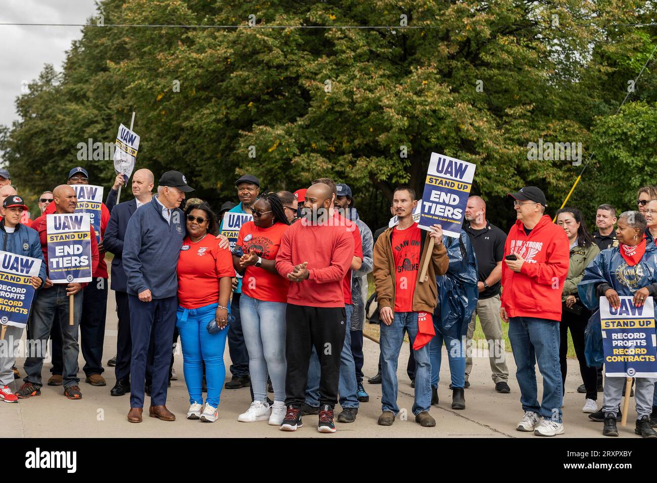 Belleville, United States. 26th Sep, 2023. U.S. President Joe Biden embraces union workers as he joins the United Auto Workers picket line outside the GM Willow Run Distribution Center, September 26, 2023, in Belleville, Michigan. Biden is the first sitting president to join a picket line in support for union workers. Credit: Adam Schultz/White House Photo/Alamy Live News Stock Photo
