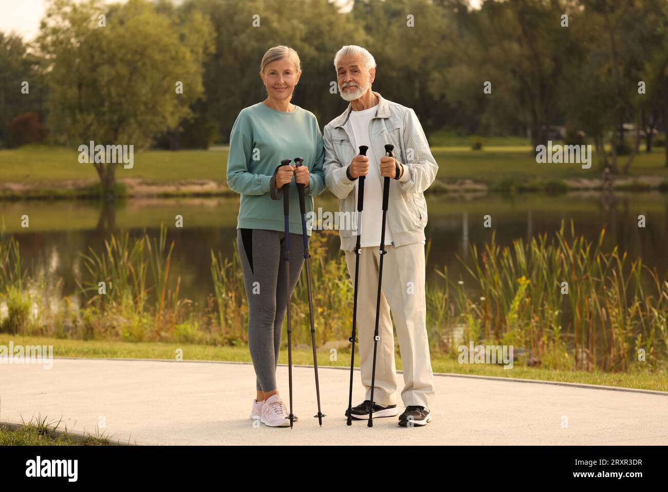 Senior man and woman with Nordic walking poles outdoors Stock Photo - Alamy