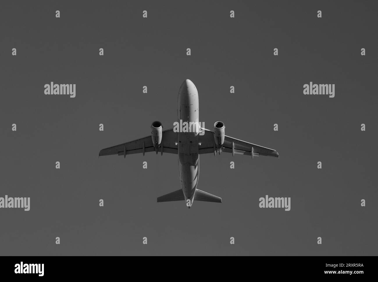 Black and white view of a 737 flying from below. Stock Photo