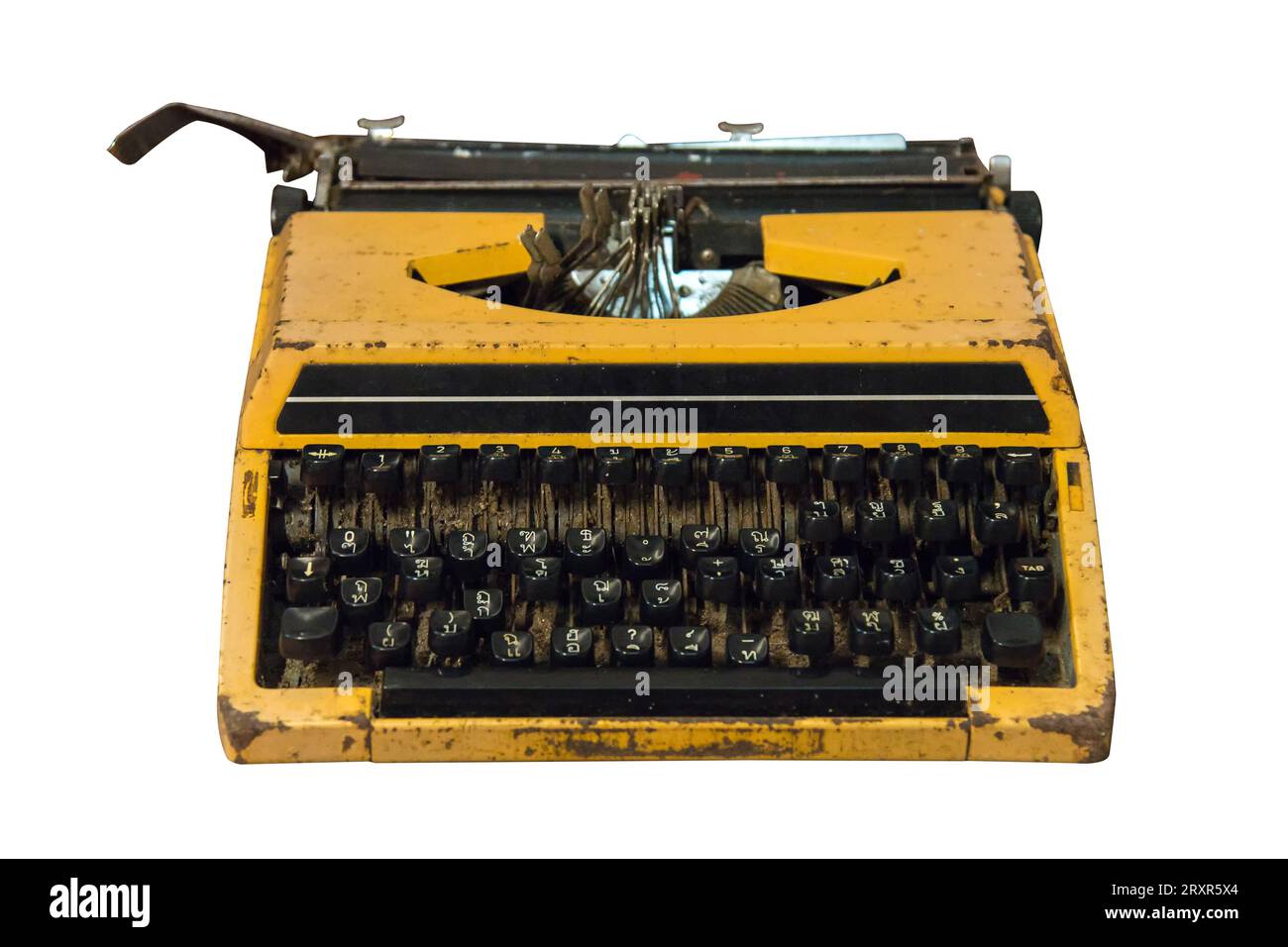 Rusty old vintage yellow typewriter isolated on white background, work with clipping path. Stock Photo