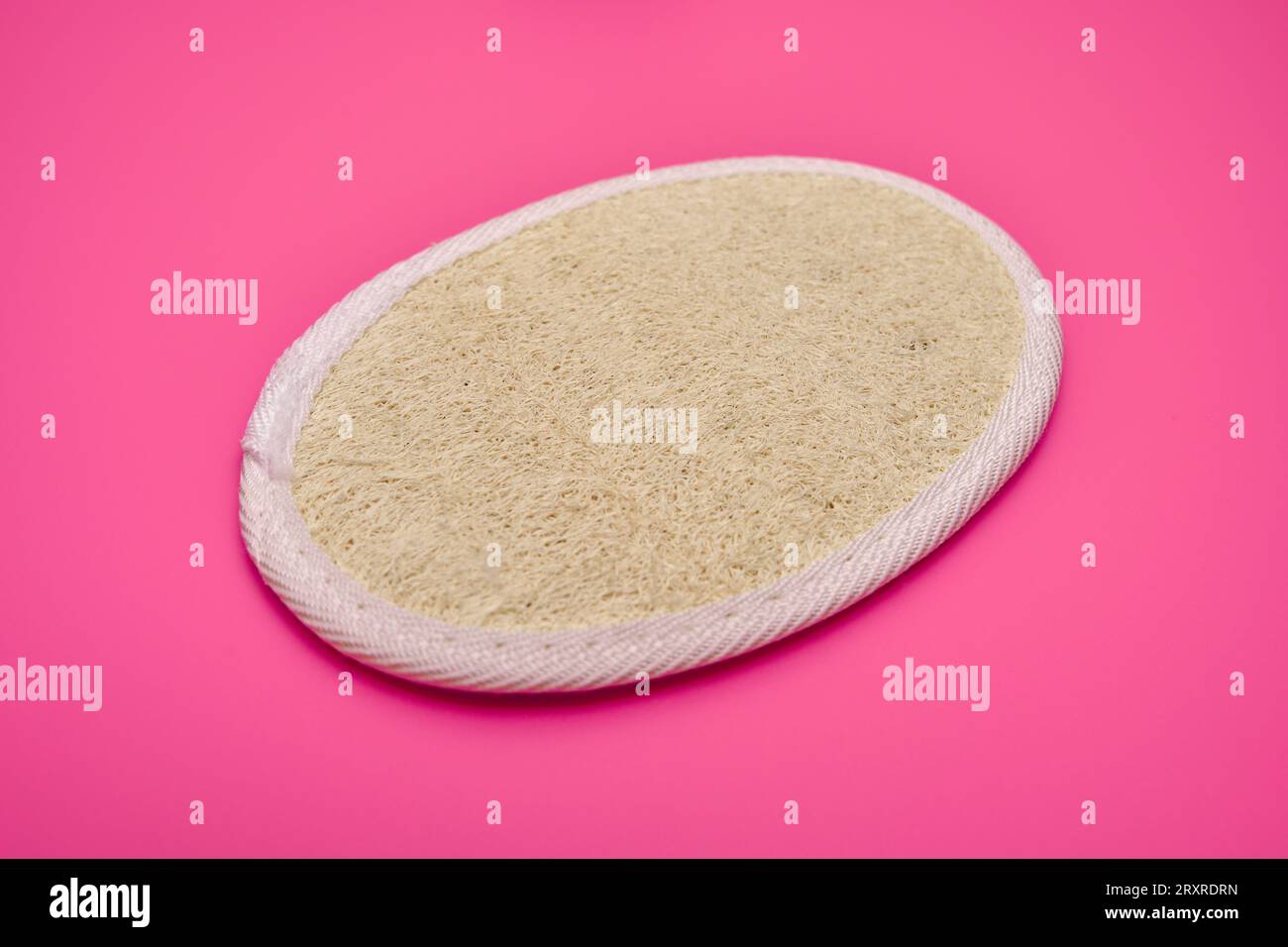 Pink background, disposable body scrub shower sponge made of loofah