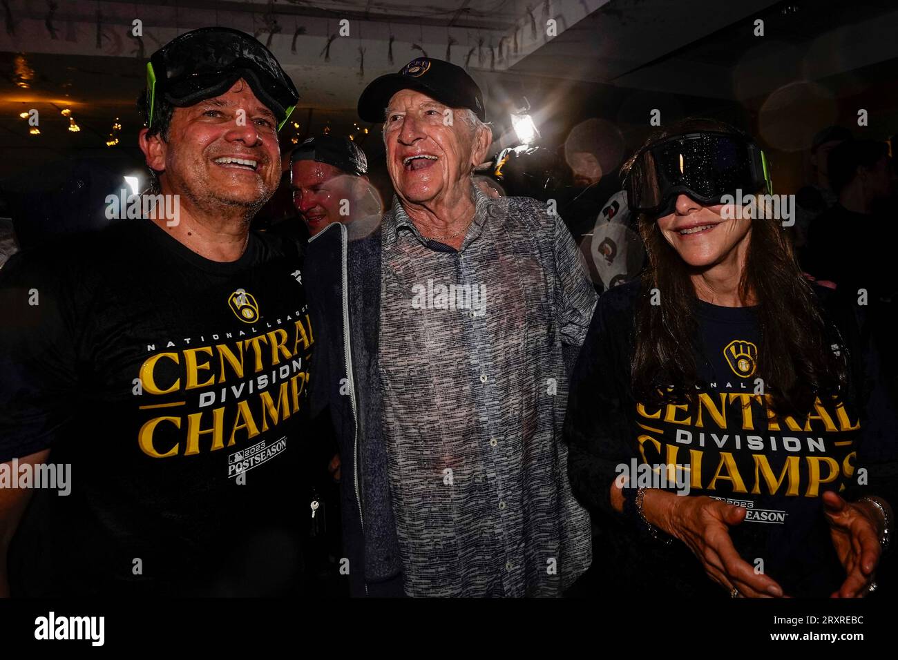 Milwaukee Brewers' owner Mark Attanasio and wife Debbie celebrate with  broadcaster Bob Uecker after clinching the National League Central Division  after a baseball game against the St. Louis Cardinals Tuesday, Sept. 26