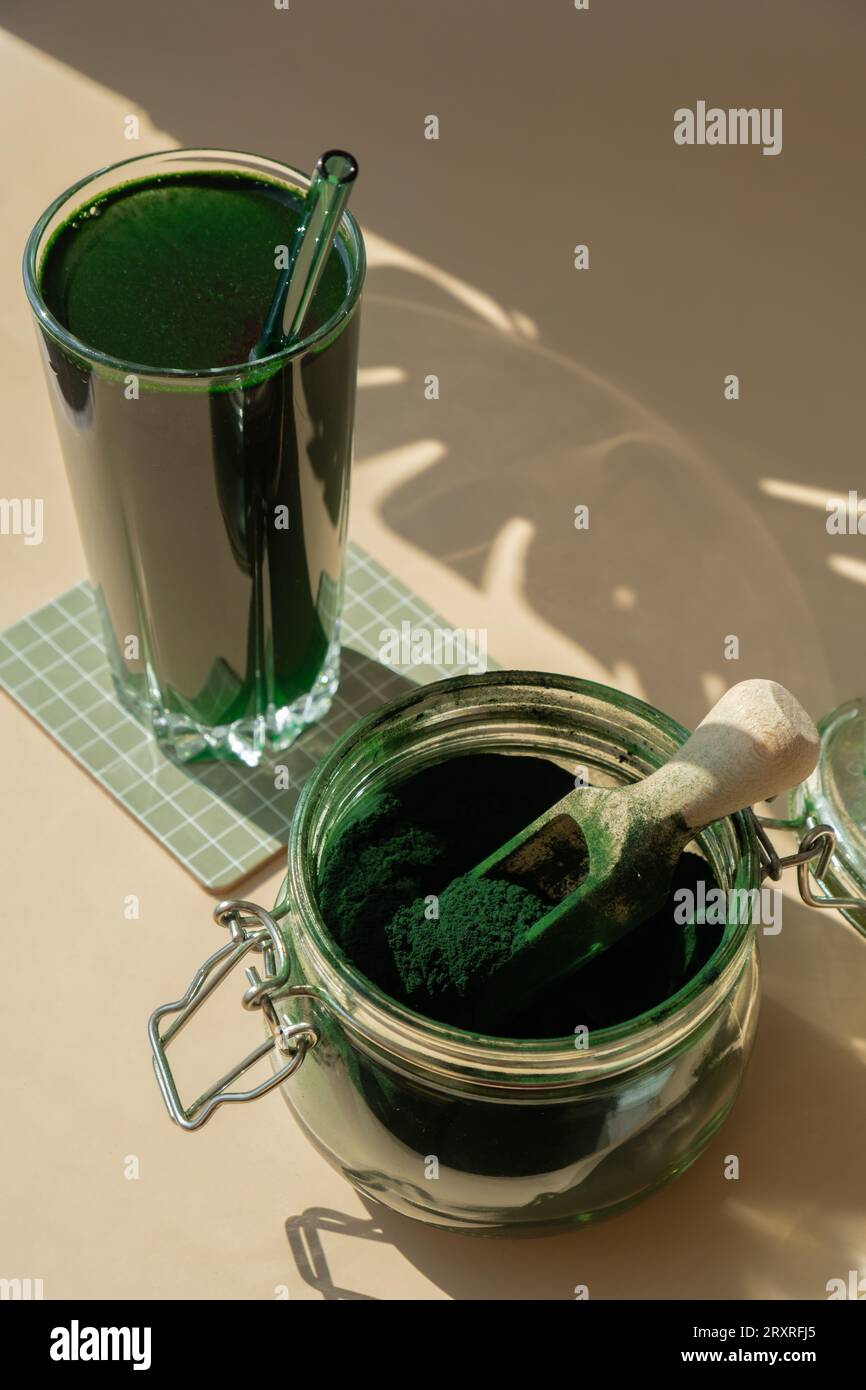 Natural organic green spirulina algae powder drink on neutral beige