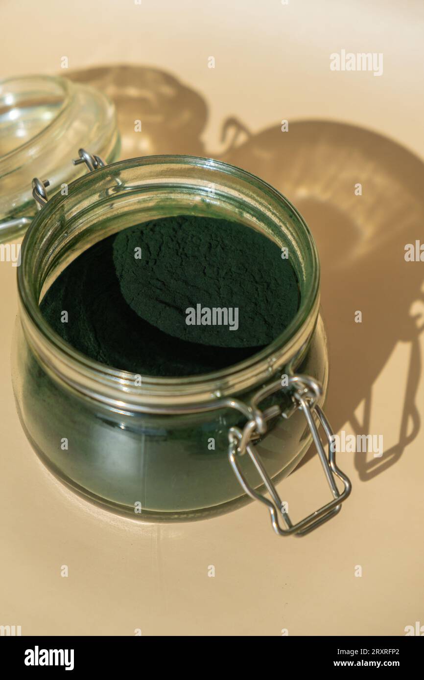 Organic bluegreen algae spirulina powder food in glass jar. Health