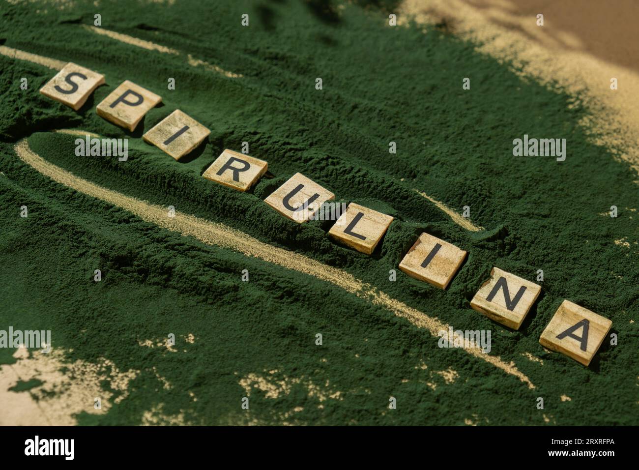 SPIRULINA letter chlorella on green background of algae superfood. Organic bluegreen algae