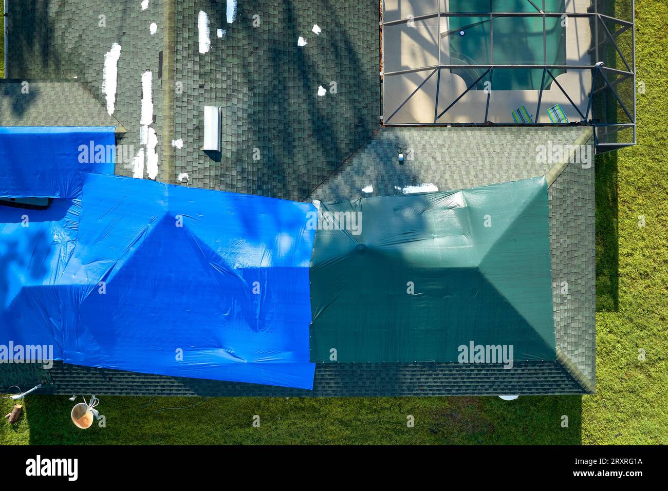 Hurricane Ian damaged house rooftop covered with protective plastic