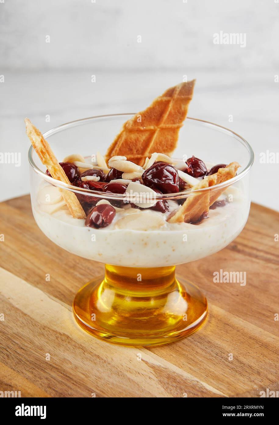 Cherries delicacy white cheese biscuits almond chips. Stock Photo