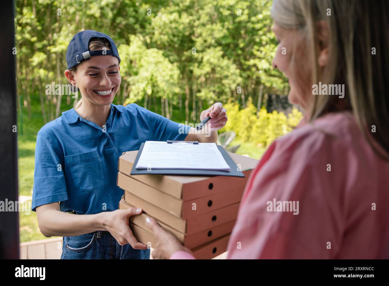 Postman carrying package documents hi-res stock photography and images ...