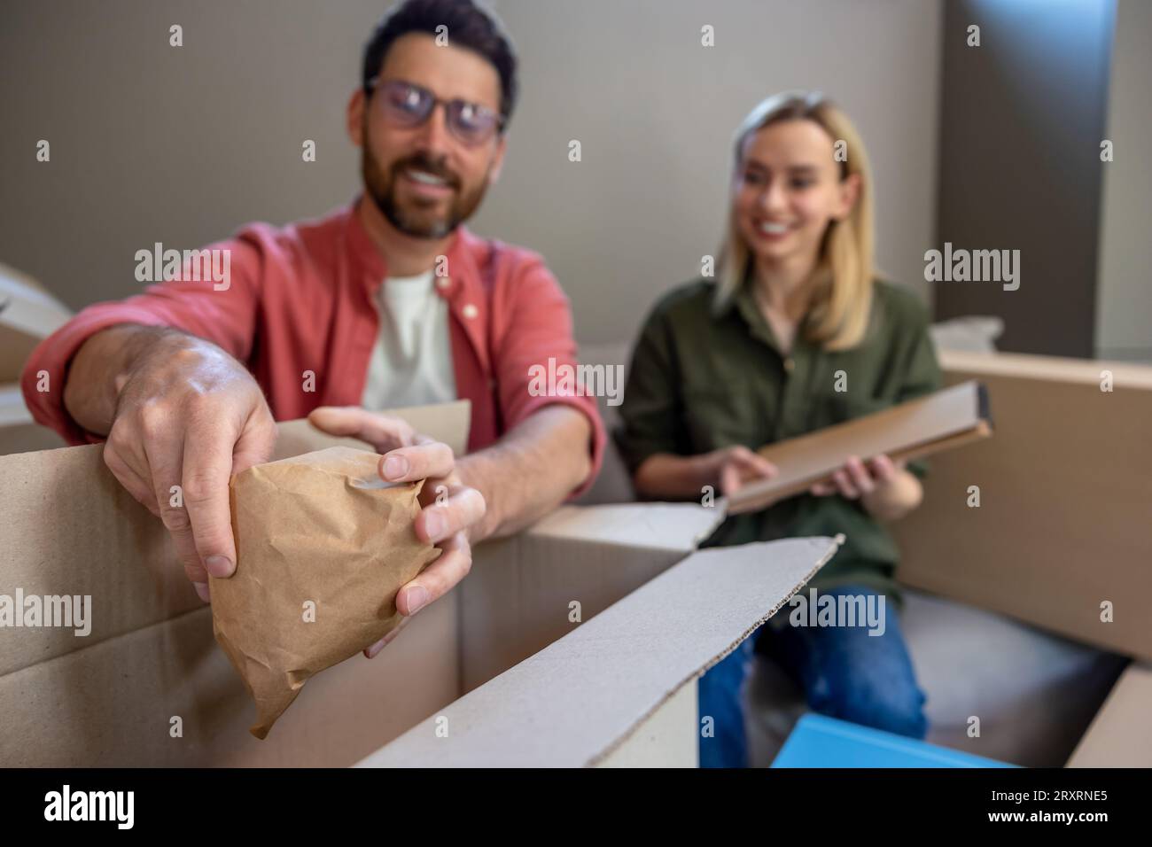 Two people looking busy while packing the boxes for relocation Stock ...