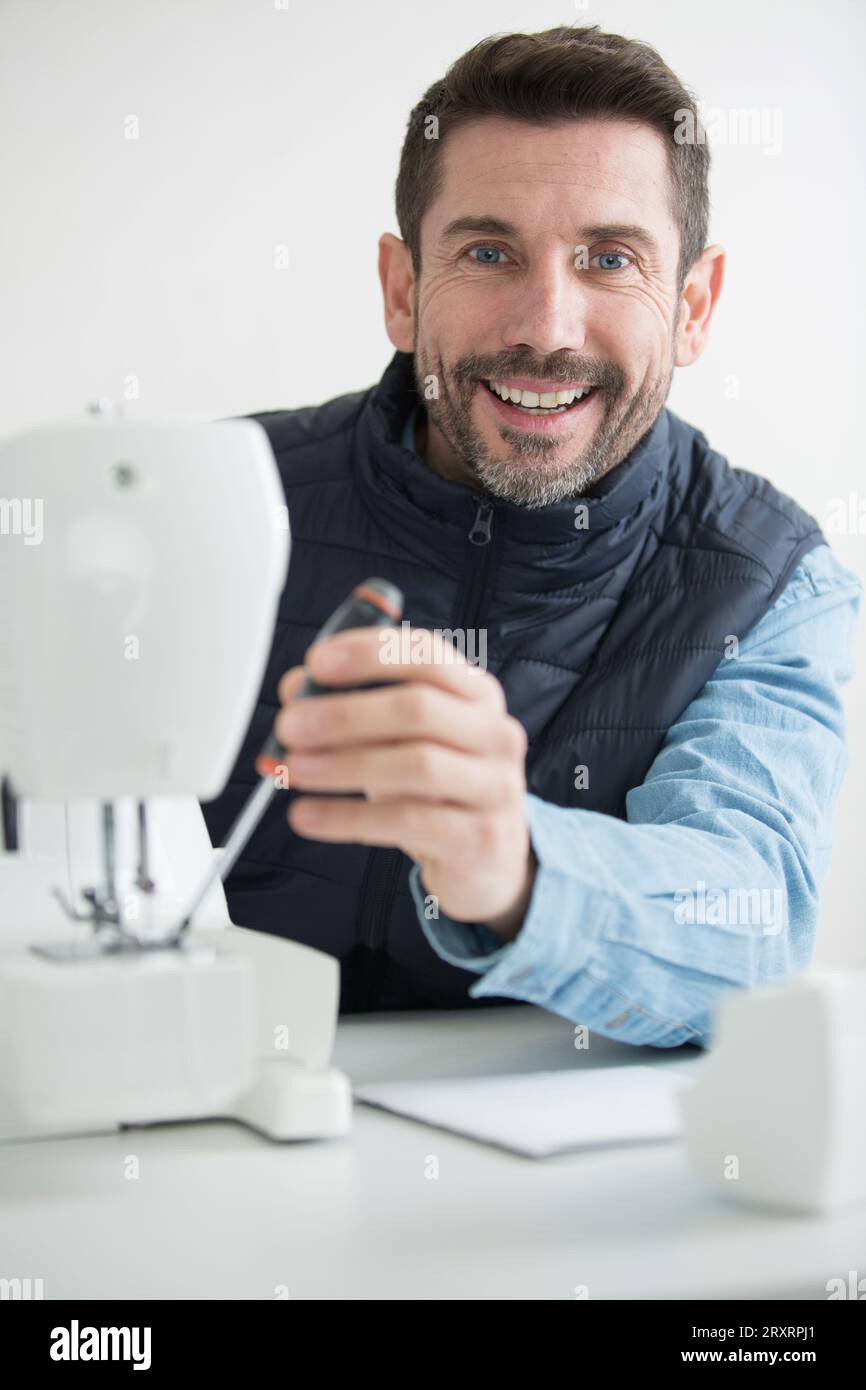 man repairing a sewing machine Stock Photo