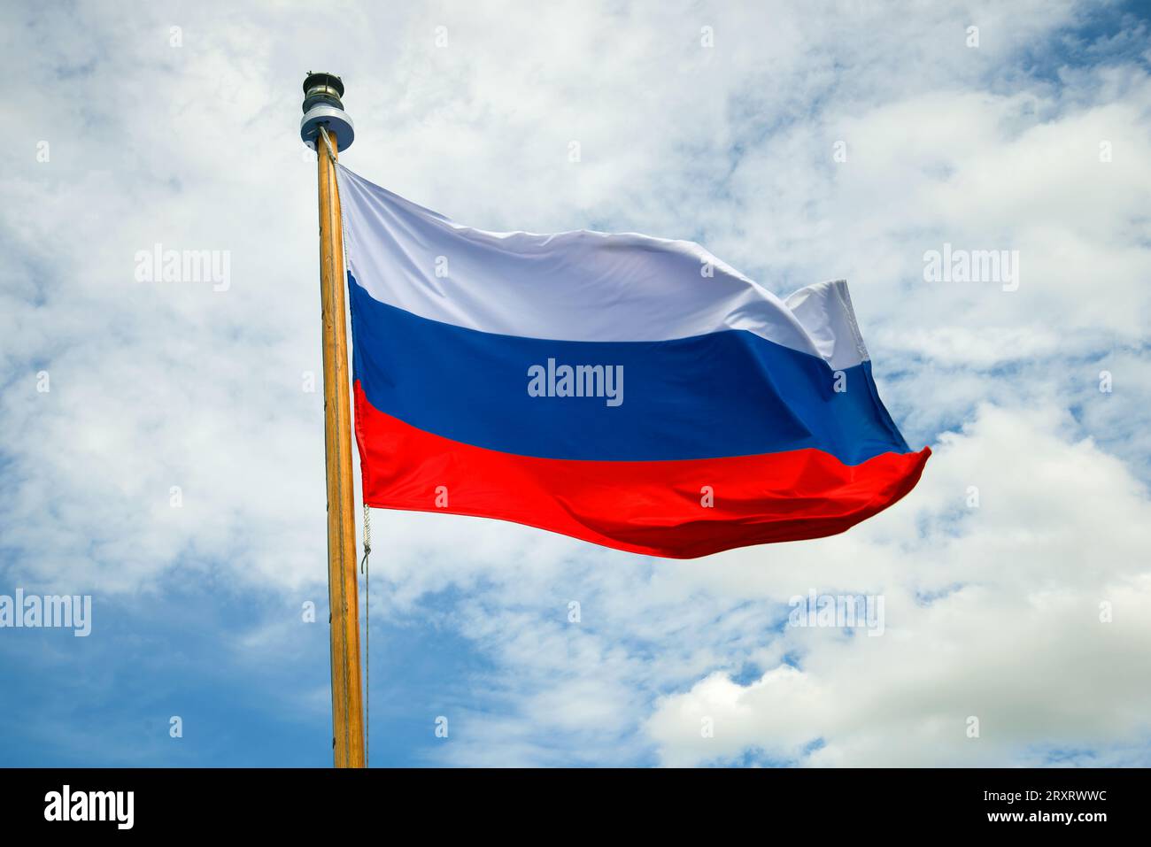 Russian flag close-up against a cloudy sky background Stock Photo