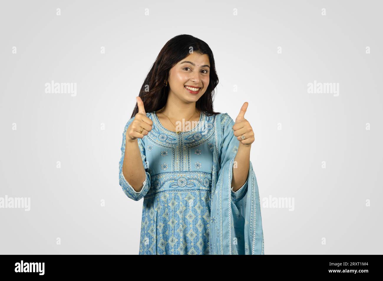 Young Smiling Asian Nepali Indian Housewife giving several best gestures  and poses with greeting Stock Photo