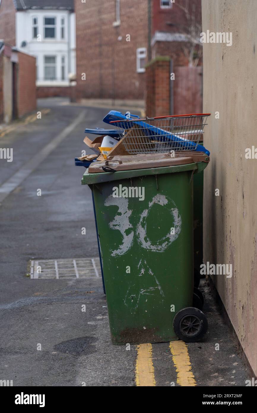 overflowing rubbish bin in a back alley in redcar, North Yorkshire