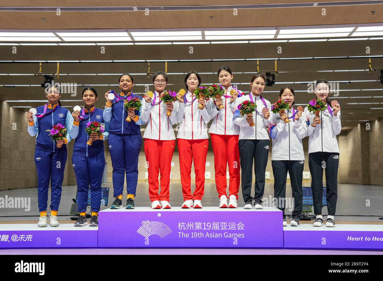 HANGZHOU, Sept. 27, 2023 (Xinhua) -- Silver medalists Team India, gold medalists Team China and bronze medalists Team South Korea (L-R) attend the awarding ceremony for the Women's Team 50m Rifle 3 Positions of Shooting at the 19th Asian Games in Hangzhou, east China's Zhejiang Province, Sept. 27, 2023. (Xinhua/Sun Fei) Stock Photo