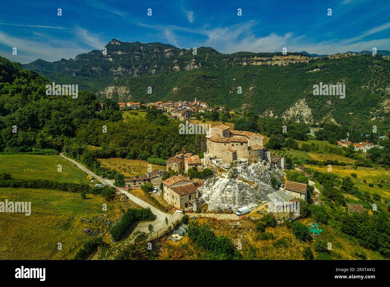 Aerial view of the historic residence of the Castle of Luco, in the background the town of Acquasanta Terme. province of Ascoli Piceno, Italy Stock Photo