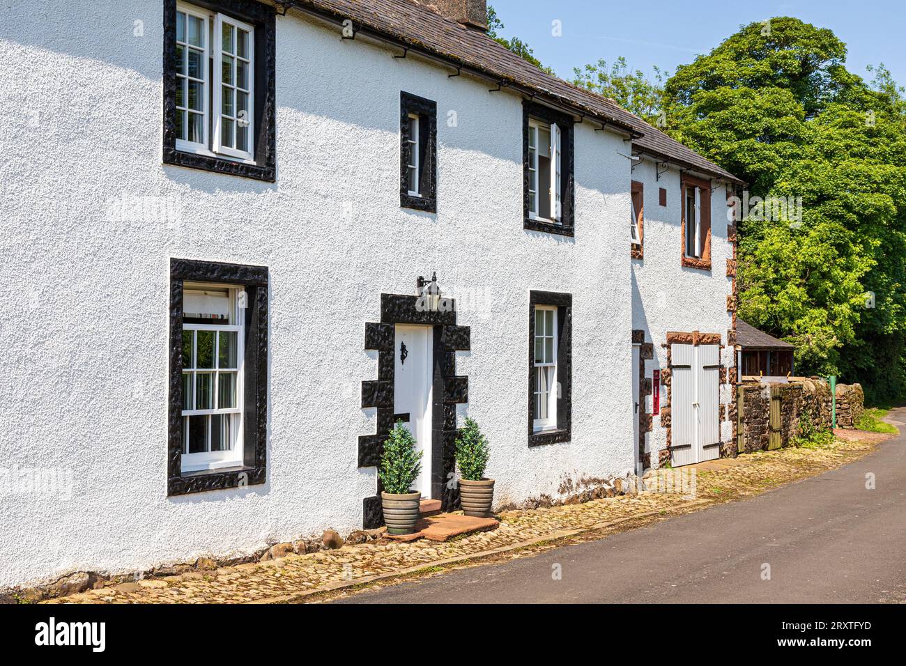 Traditional 18th century farm house with rusticated stone surrounds to windows and door at Greenwell near the village of Castle Carrock, Cumbria UK Stock Photo