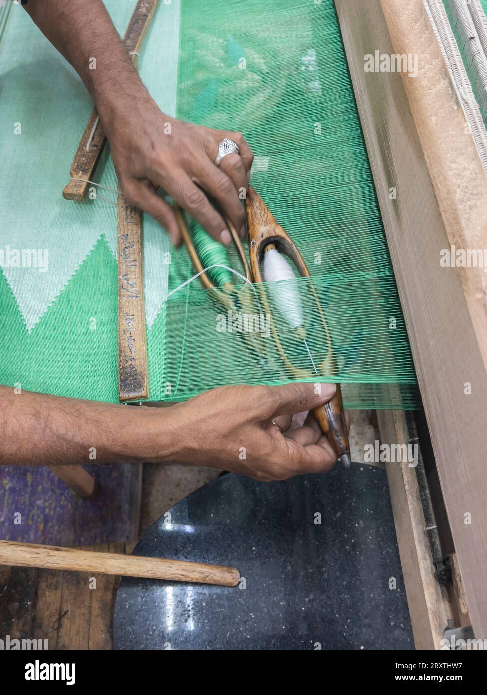 Egyptian man working on a loom in a shop at the unfinished obelisk in Aswan, Egypt, North Africa, Africa Stock Photo