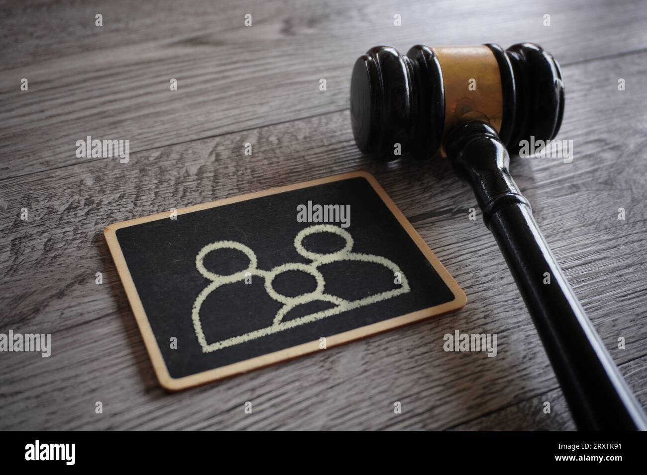 Closeup image judge gavel and chalkboard with family icon. Guardianship, family law concept. Stock Photo