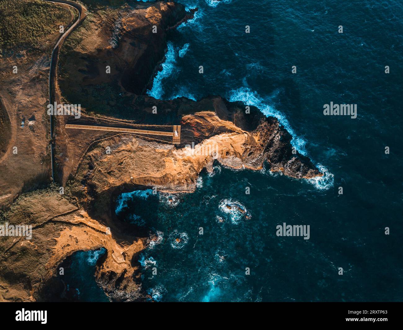 Aerial view of the coasts and cliffs of the island of Sao Miguel over the lighthouse of Farolim dos Fenais da Ajuda, Azores Islands, Portugal Stock Photo