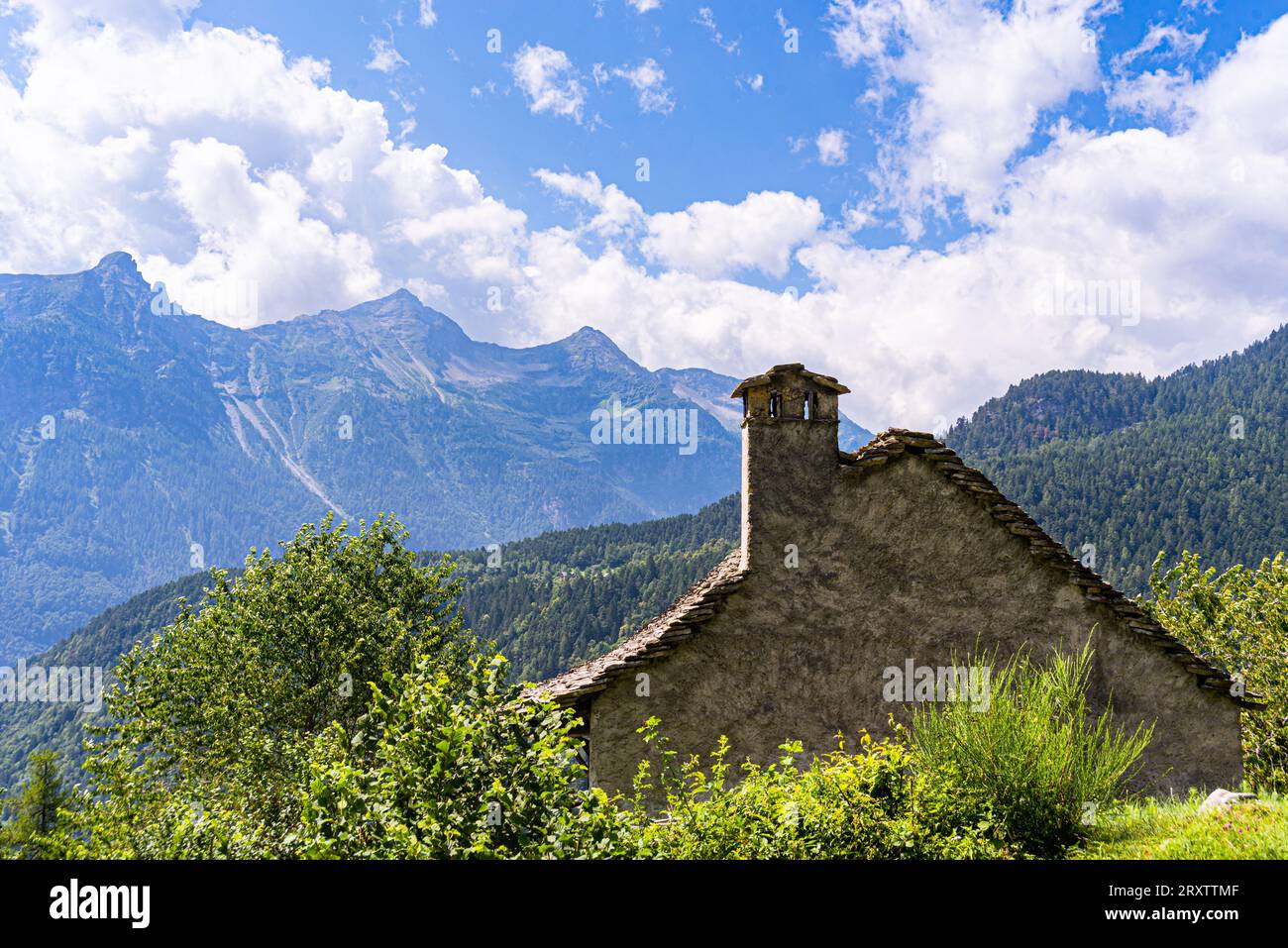 A traditional rural architecture style house built of rocks from the mountain in a beautiful alpine valley in summer, Piemonte (Piedmont) Stock Photo