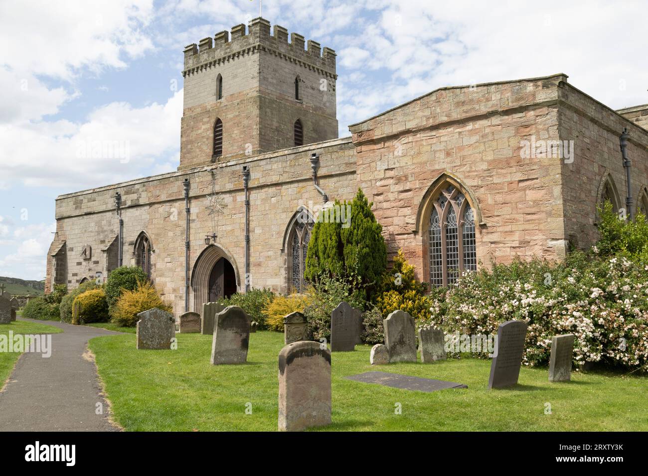 St. Aidan's Church, a 12th century place of worship, a key location in spreading Christianity during the Anglo-Saxon era, and its churchyard Stock Photo