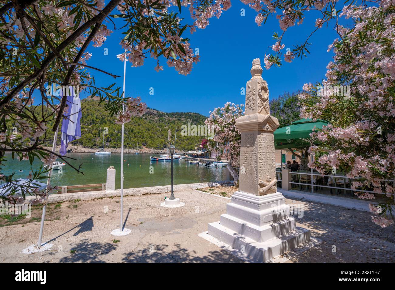 View of statue and colourful houses in Assos, Assos, Kefalonia, Ionian