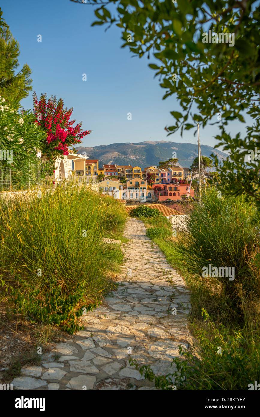 Path leading to harbour and colourful houses in Assos, Assos, Kefalonia, Ionian Islands, Greek Islands, Greece, Europe Stock Photo