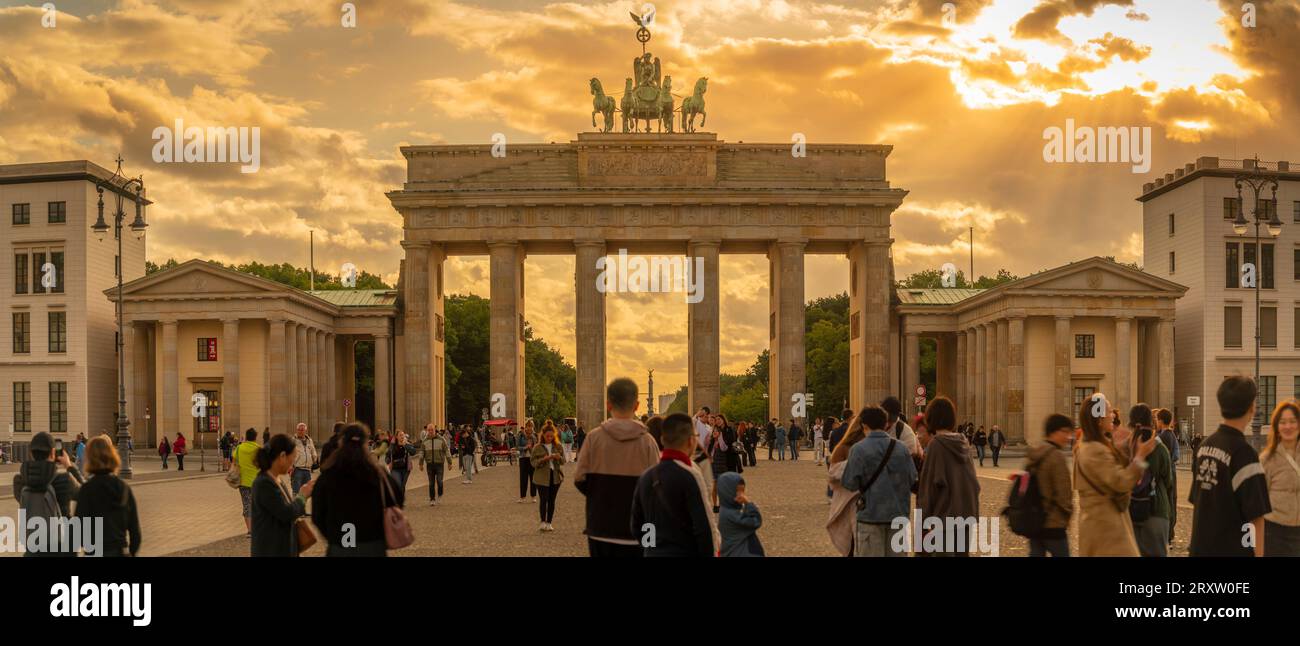 View of people gathered at Brandenburg Gate at sunset, Pariser Square, Unter den Linden, Berlin, Germany, Europe Stock Photo
