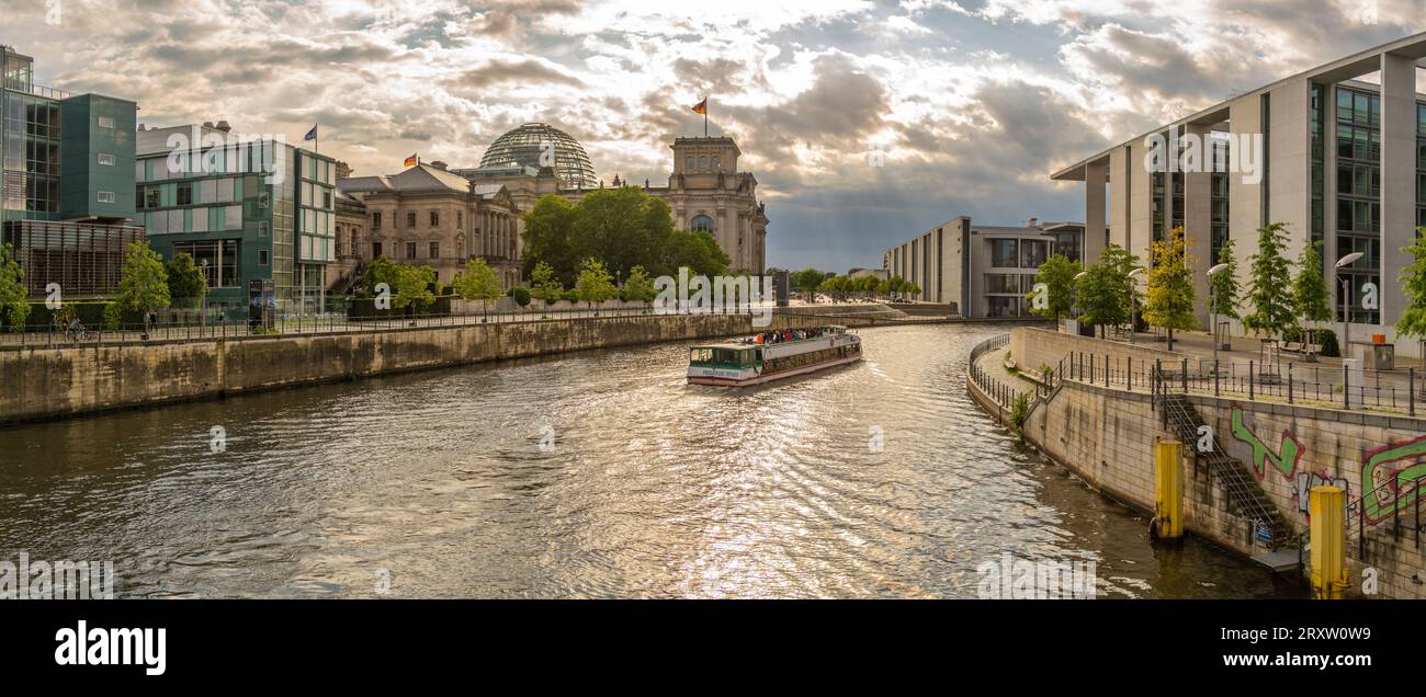 View of sightseeing cruise boat on River Spree and the Reichstag (German Parliament building), Mitte, Berlin, Germany, Europe Stock Photo
