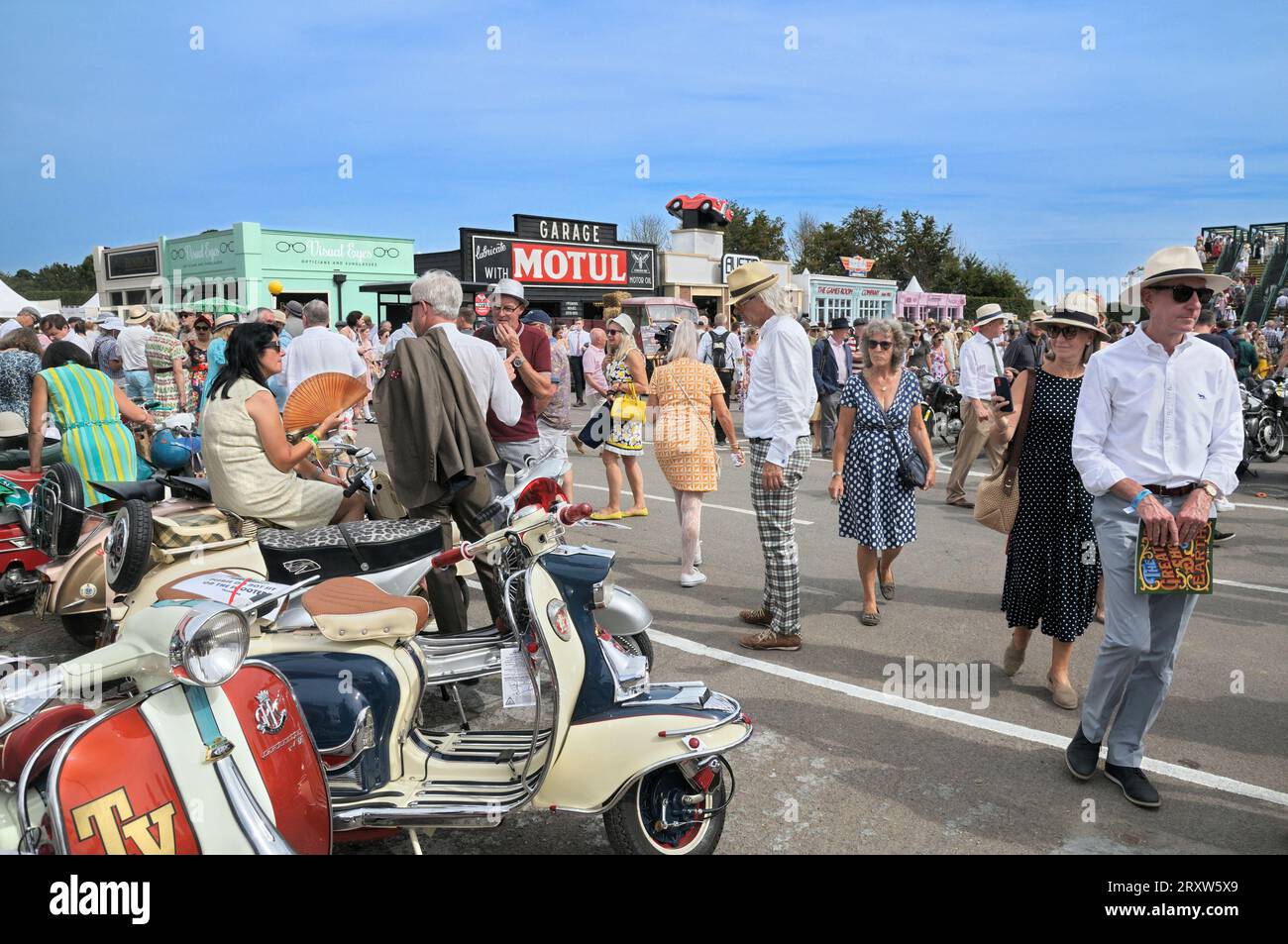 The famous Goodwood Revival festival, Chichester, West Sussex, England, UK. People visiting Revival High Street with its set of period themed shops. Stock Photo