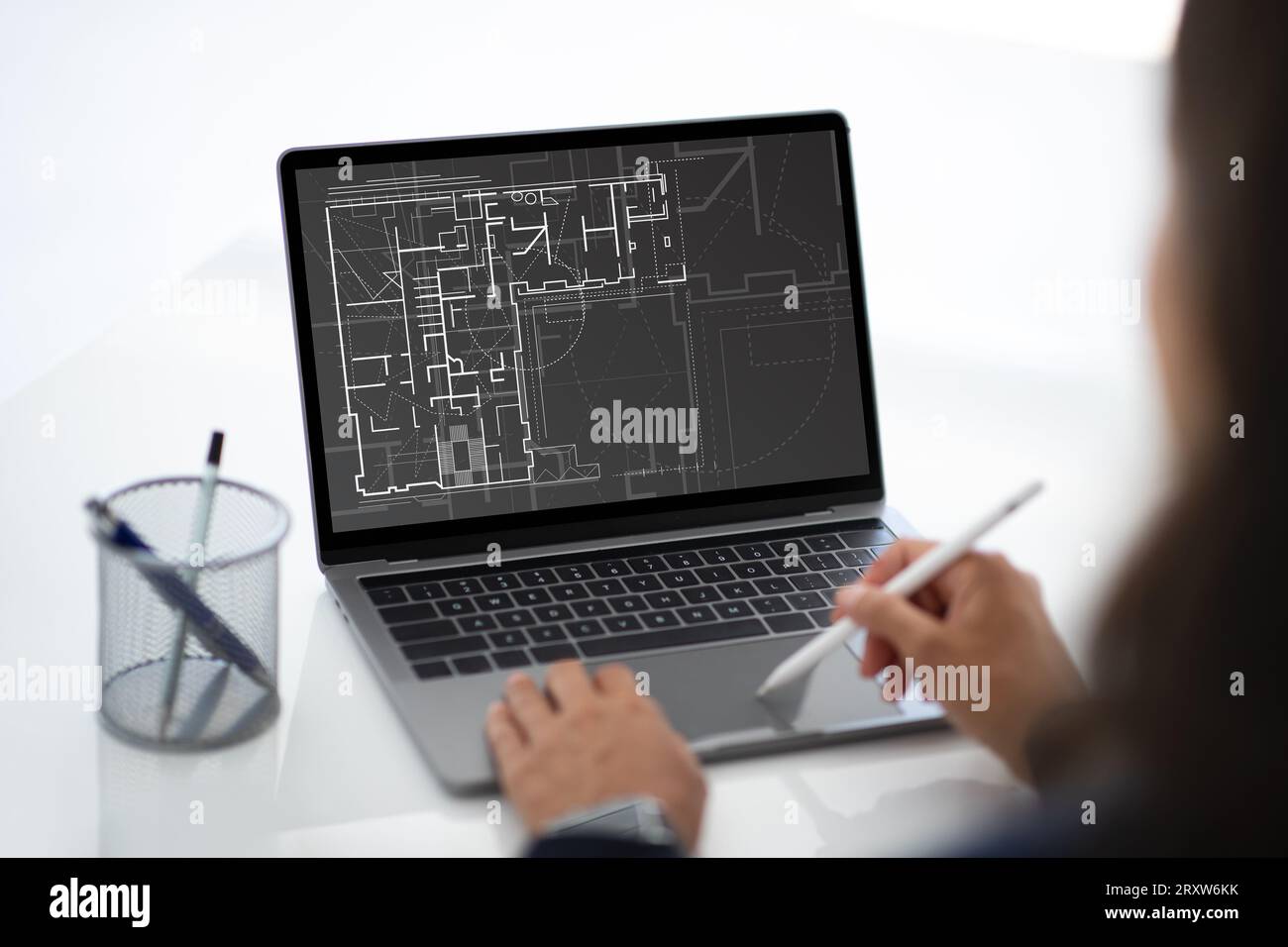 Architect designer using laptop and stylus while working in office Stock Photo
