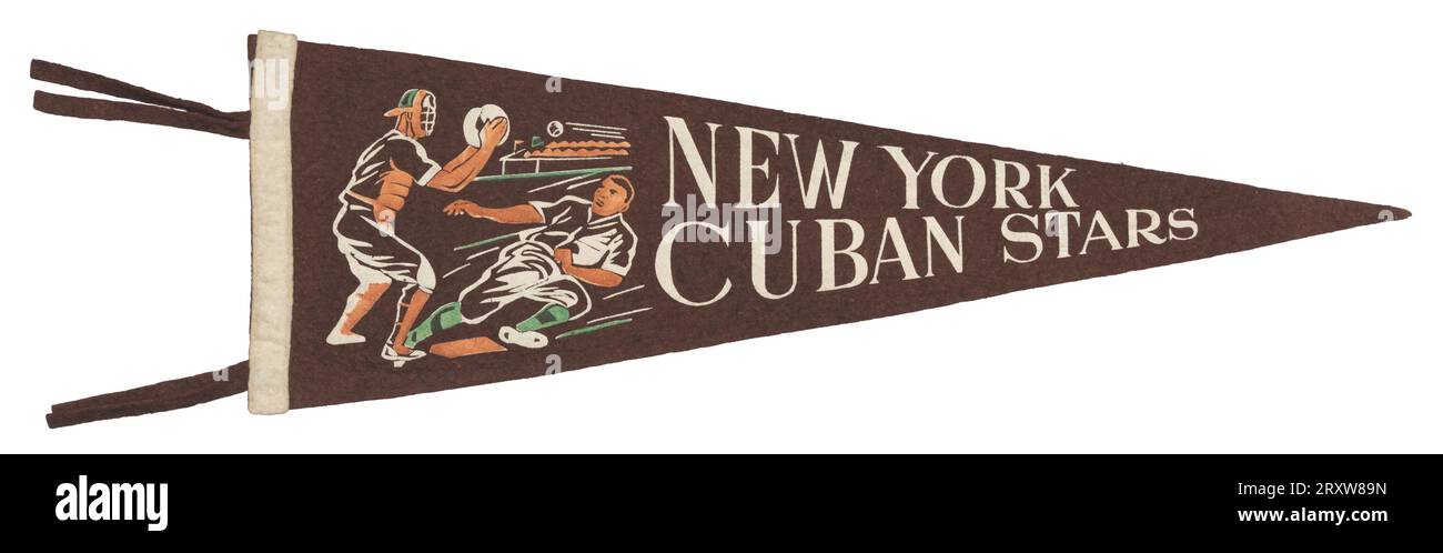 Triangular New York Cuban Stars felt baseball pennant. The pennant is primarily made of brown felt with a strip of white felt stitched to the left edge with four brown tassles. There is a green, white, and orange screen-printed image of a baseball player sliding into home plate with the catcher standing behind the plate, ready to catch the baseball coming towards him. There is white text next to the image that reads 'NEW YORK CUBAN STARS.' Stock Photo