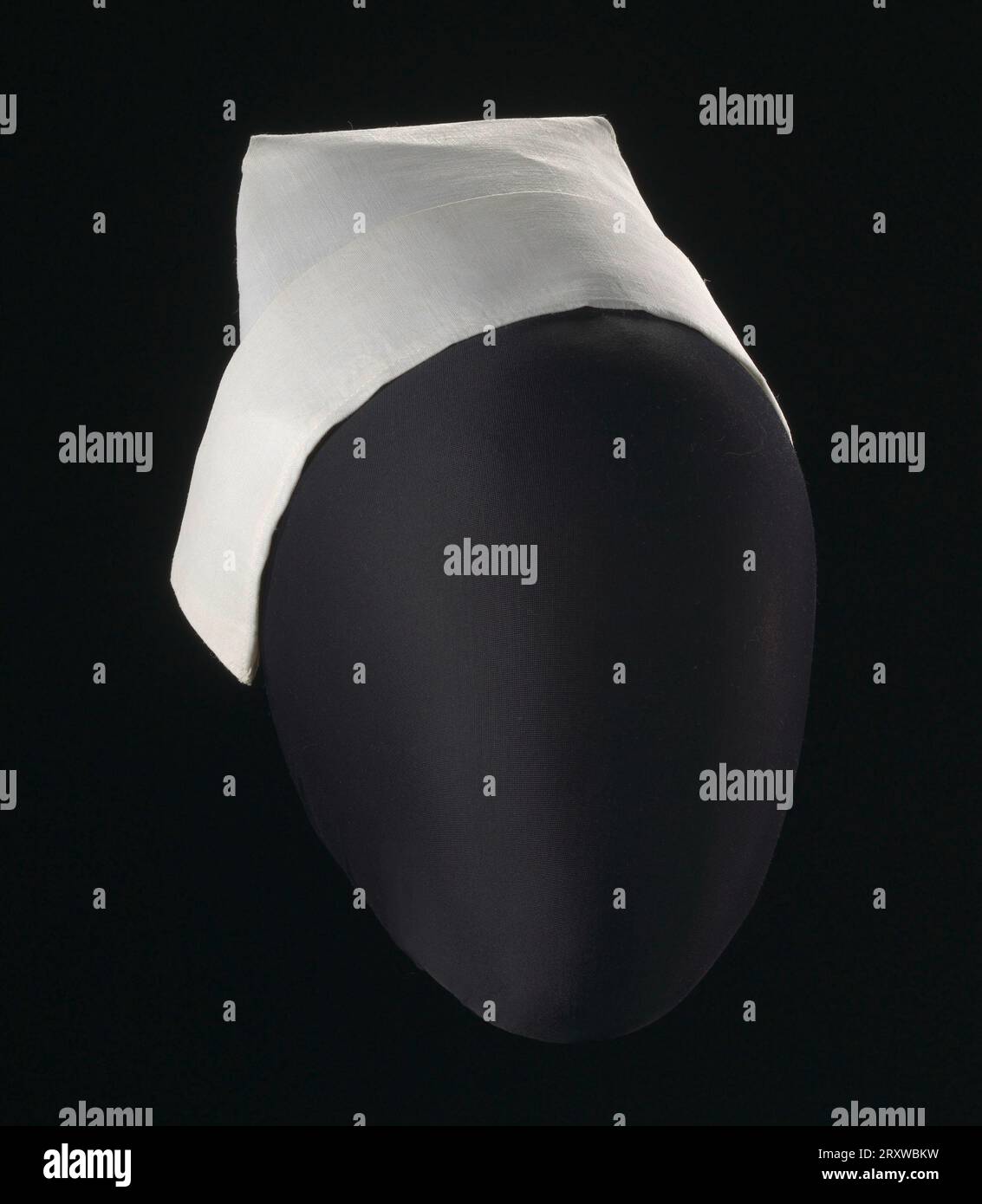 White nurses cap with folded back brim. Edges of the cap fasten to the