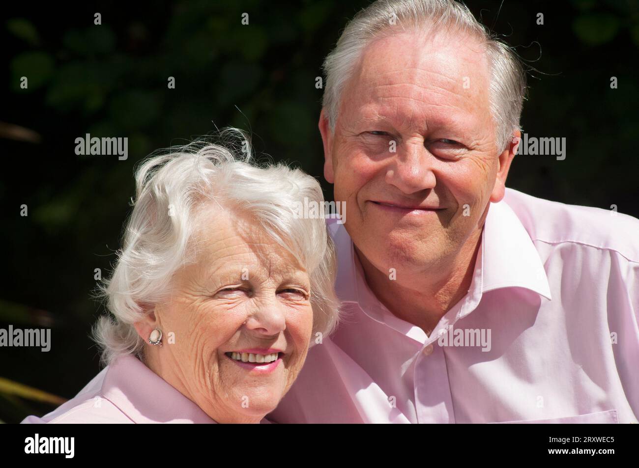 Happily married senior couple posing in front of the camera - John Gollop Stock Photo