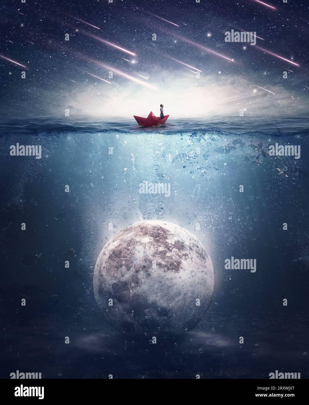 Boy sailing in a paper boat searching for the moon sunken underwater. Satellite drowned in the ocean water in a mysterious night with falling stars. S Stock Photo