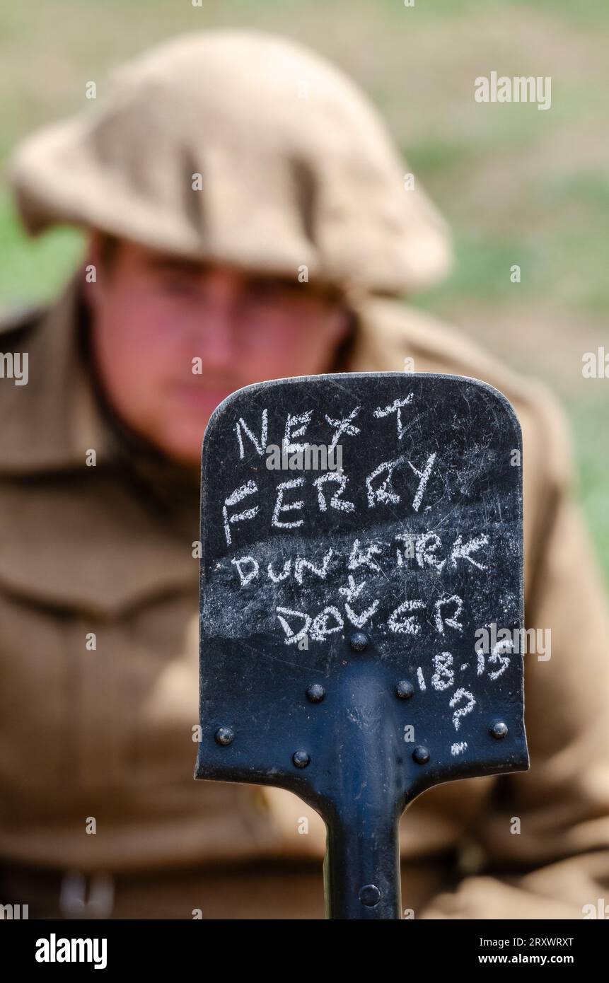 Dunkirk evacuation re-enactment scenario with a chalked message on a shovel indicating the next ferry to Dover. Second World War enactment. War humour Stock Photo