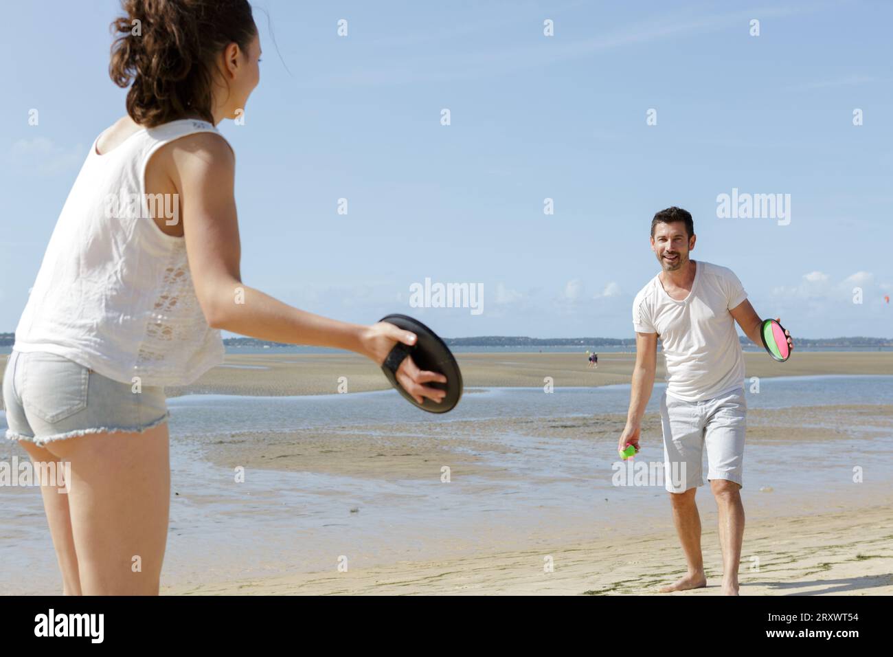 active couple playing ball game on the beach Stock Photo Alamy
