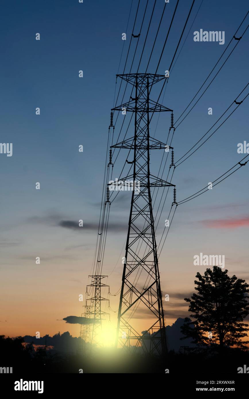 High voltage tower with power lines with Sunlight ray in the evening ...