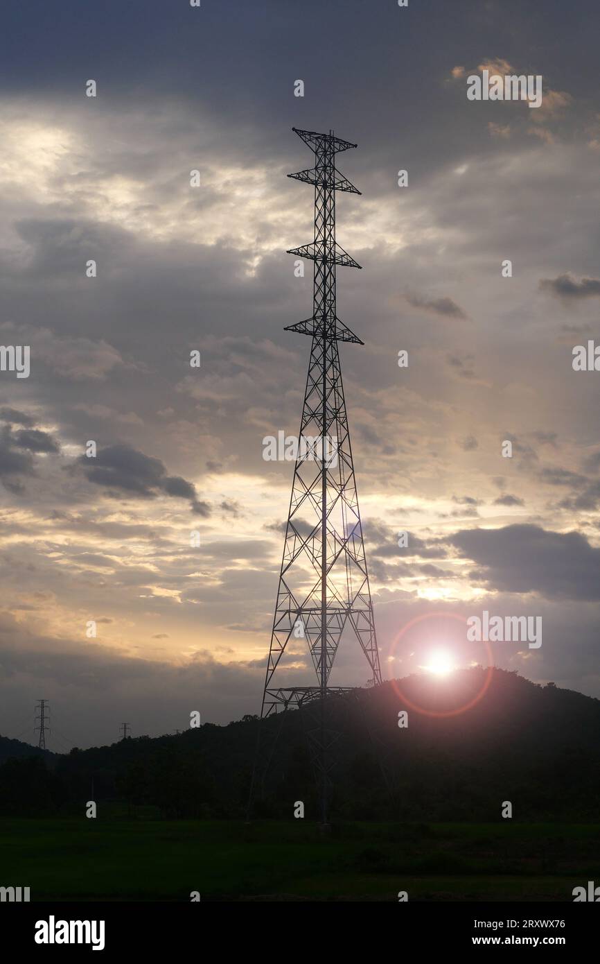 High voltage tower with power lines with Sunlight ray in the evening ...